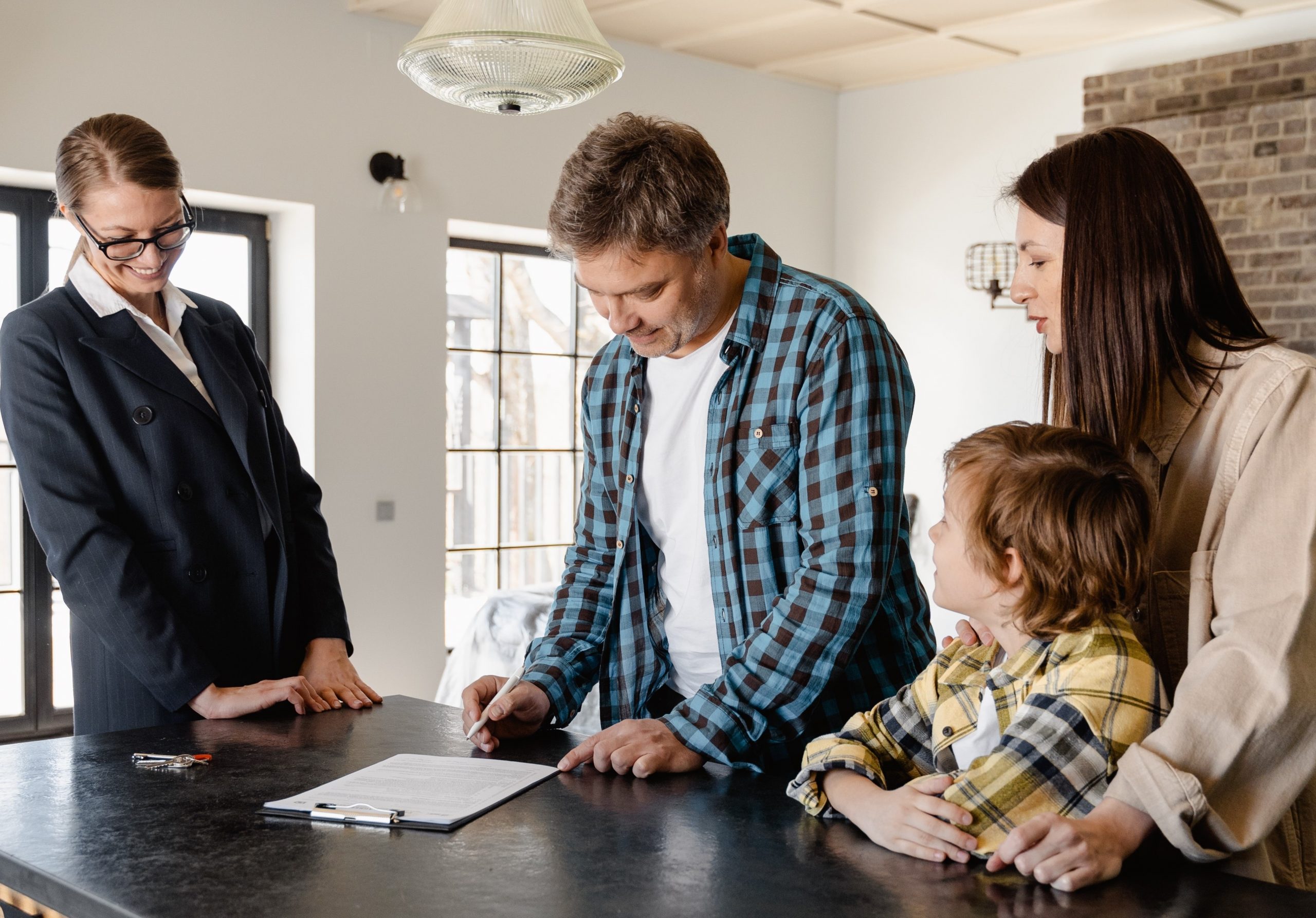Realtor with Clients signing a form