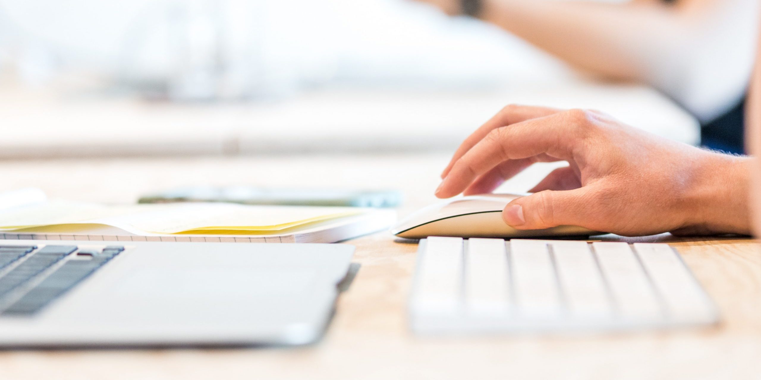 A person using a keyboard and a mouse